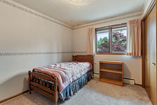 1610 E 35th Ave, Spokane, WA 99203 - bedroom featuring a baseboard heating unit, carpet flooring, and baseboards