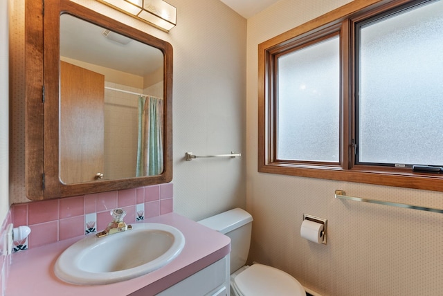 1610 E 35th Ave, Spokane, WA 99203 - bathroom with toilet, vanity, tasteful backsplash, and a shower with curtain