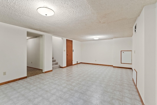 1610 E 35th Ave, Spokane, WA 99203 - finished below grade area featuring light flooring, a textured ceiling, stairs, and baseboards