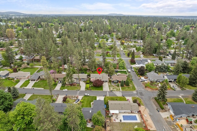 1610 E 35th Ave, Spokane, WA 99203 - aerial view of property and surrounding area featuring nearby suburban area, a heavily wooded area, and mountains