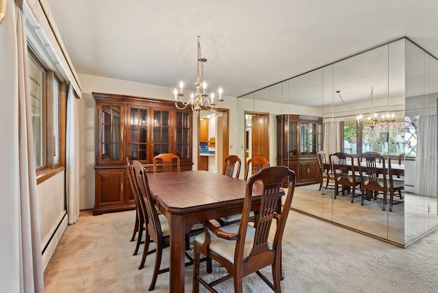 1610 E 35th Ave, Spokane, WA 99203 - dining space with a chandelier, a baseboard heating unit, and light colored carpet