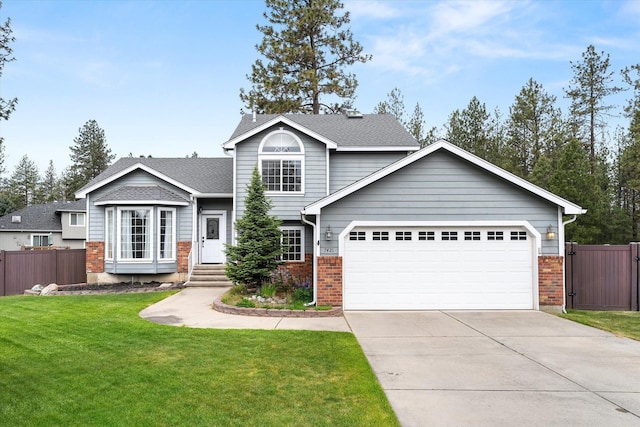 7421 W Lanzce Ct, Nine Mile Falls, WA 99026 - view of front of home with an attached garage, brick siding, and driveway
