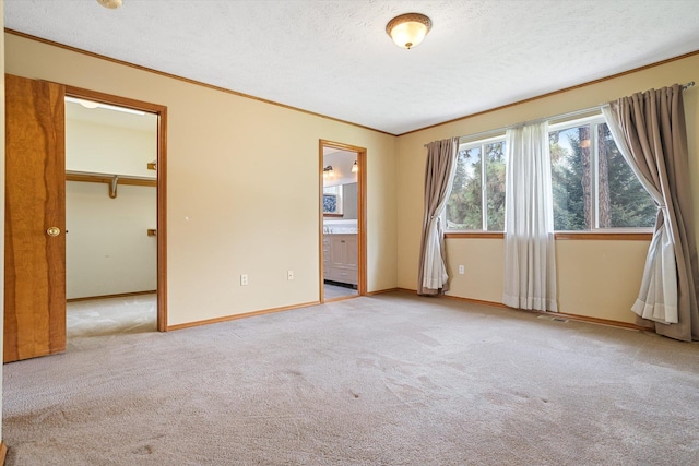 7421 W Lanzce Ct, Nine Mile Falls, WA 99026 - empty room with carpet, a textured ceiling, crown molding, and baseboards