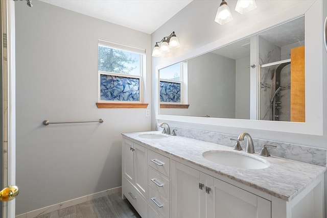 7421 W Lanzce Ct, Nine Mile Falls, WA 99026 - full bathroom featuring double vanity, wood finished floors, and a shower stall