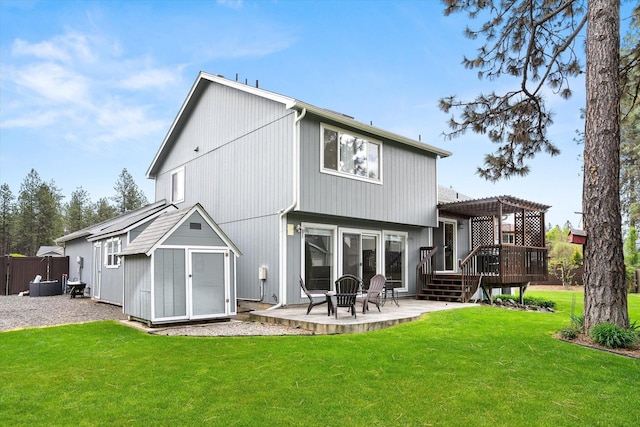 7421 W Lanzce Ct, Nine Mile Falls, WA 99026 - rear view of property featuring a pergola, a wooden deck, a lawn, a storage unit, and a patio area