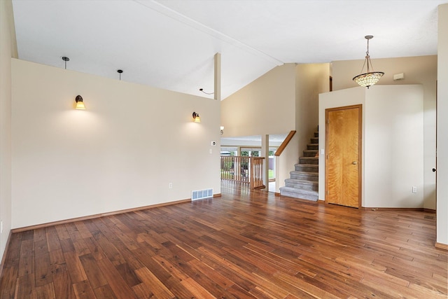 7421 W Lanzce Ct, Nine Mile Falls, WA 99026 - unfurnished living room featuring high vaulted ceiling, hardwood / wood-style floors, stairs, and baseboards