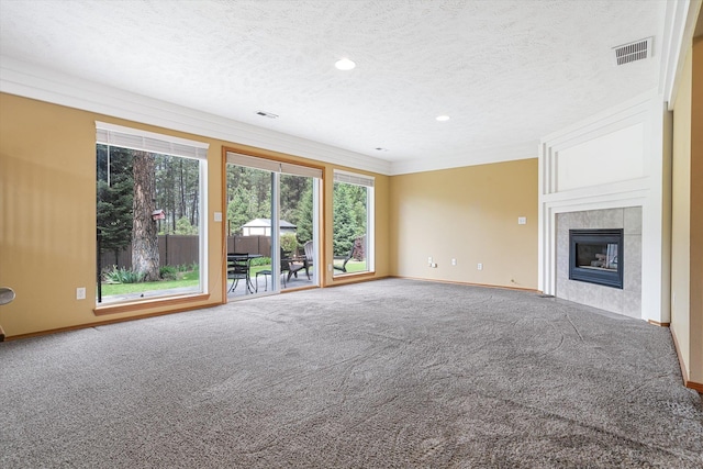 7421 W Lanzce Ct, Nine Mile Falls, WA 99026 - unfurnished living room featuring carpet flooring, baseboards, a tiled fireplace, recessed lighting, and a textured ceiling
