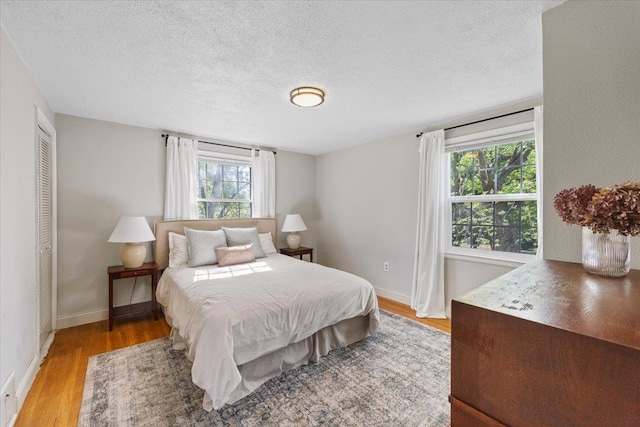 1421 N Sunderland Rd, Spokane Valley, WA 99206 - bedroom with a textured ceiling, light wood-style flooring, and baseboards