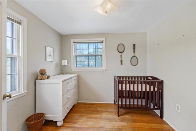 1421 N Sunderland Rd, Spokane Valley, WA 99206 - bedroom with light wood-style floors, a nursery area, and baseboards
