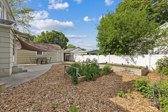 1421 N Sunderland Rd, Spokane Valley, WA 99206 - view of yard featuring a vegetable garden and a patio