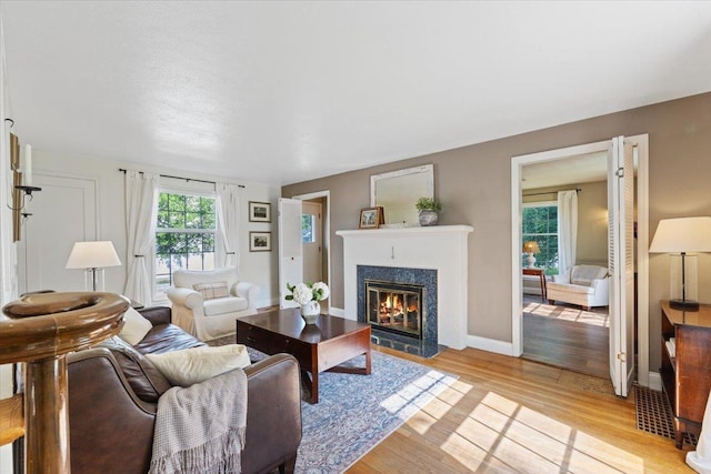 1421 N Sunderland Rd, Spokane Valley, WA 99206 - living area featuring a fireplace with flush hearth, light wood finished floors, and baseboards