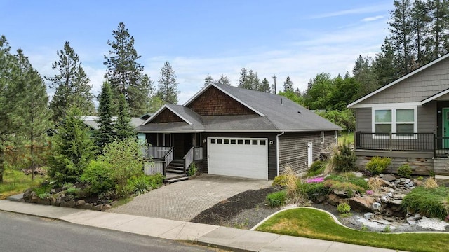 craftsman inspired home with an attached garage, driveway, and a porch