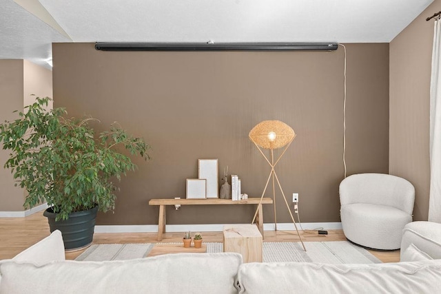 bedroom featuring baseboards and wood finished floors