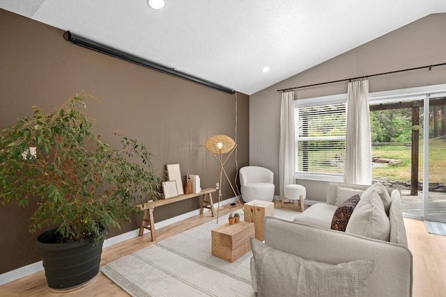 living area with lofted ceiling, wood finished floors, recessed lighting, and baseboards