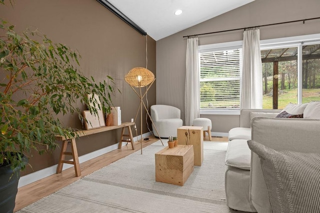 sitting room featuring lofted ceiling, baseboards, wood finished floors, and recessed lighting