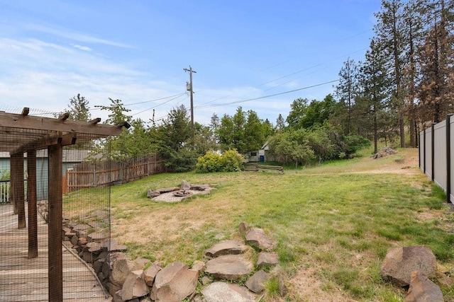view of yard featuring an outdoor fire pit and a pergola
