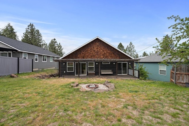 back of property with an outdoor fire pit and a patio