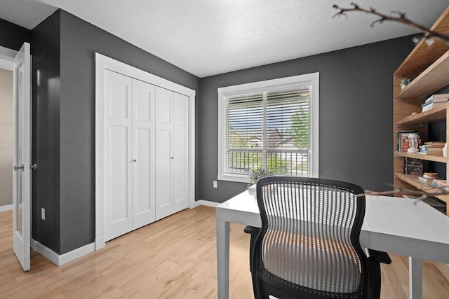 office area with light wood finished floors and baseboards