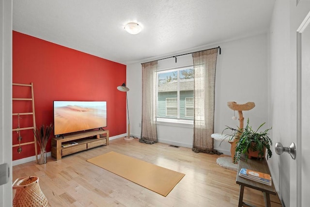 sitting room featuring wood finished floors and baseboards