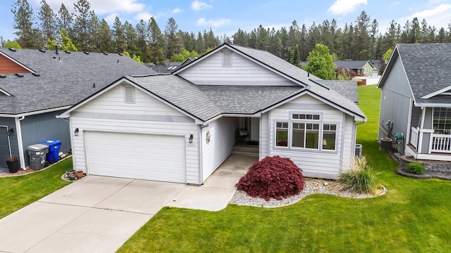 ranch-style house featuring a garage, a shingled roof, driveway, and a front lawn