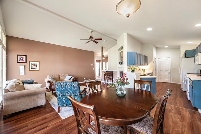 dining space with dark wood-type flooring, lofted ceiling, a ceiling fan, recessed lighting, and baseboards