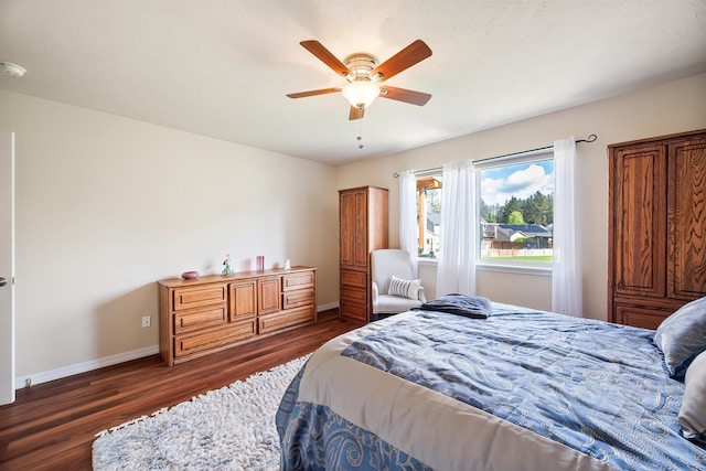 bedroom with dark wood finished floors, baseboards, and a ceiling fan