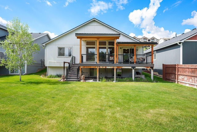 rear view of property with stairway, a deck, and board and batten siding