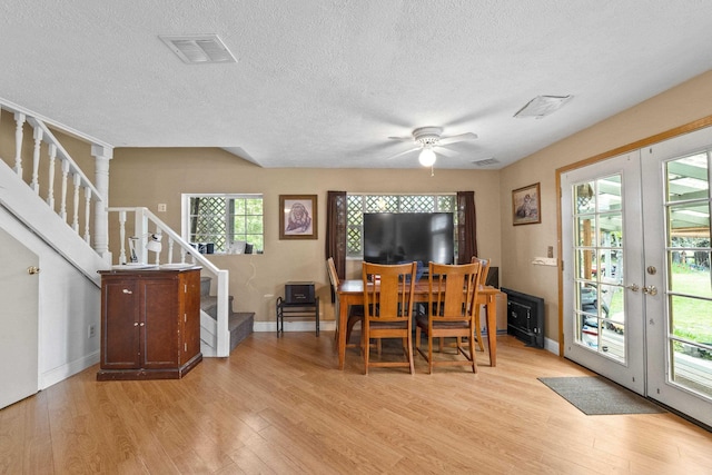 14203 E Belmont Rd, Mica, WA 99023 - dining area with french doors, light wood-style flooring, stairway, a textured ceiling, and baseboards