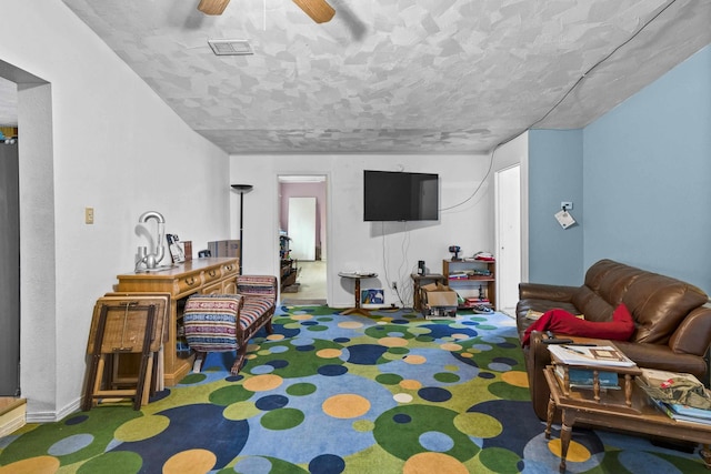 14203 E Belmont Rd, Mica, WA 99023 - carpeted living area with a ceiling fan and baseboards