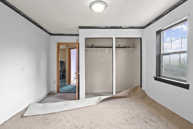 14203 E Belmont Rd, Mica, WA 99023 - unfurnished bedroom featuring carpet floors, ornamental molding, and two closets