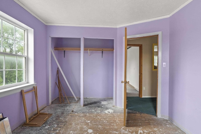 14203 E Belmont Rd, Mica, WA 99023 - unfurnished bedroom featuring multiple windows, two closets, a textured ceiling, and crown molding