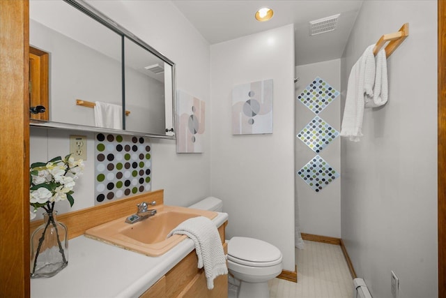 5217 E Stoughton Rd, Valleyford, WA 99036 - bathroom with toilet, vanity, a baseboard heating unit, and baseboards