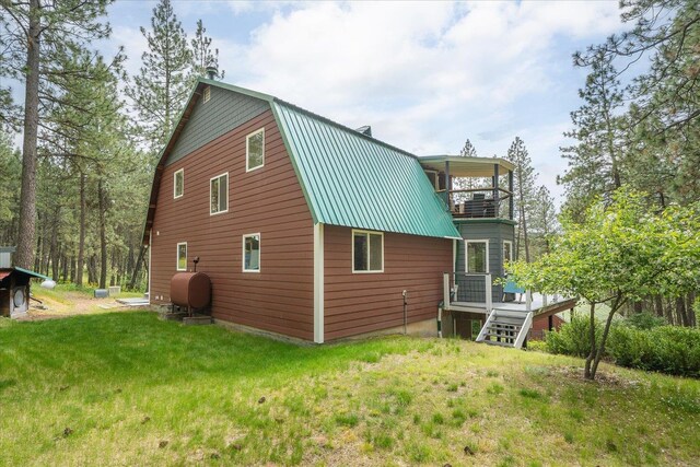 5217 E Stoughton Rd, Valleyford, WA 99036 - rear view of property featuring heating fuel, a gambrel roof, metal roof, a lawn, and a balcony