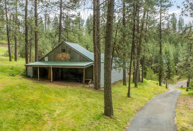 5217 E Stoughton Rd, Valleyford, WA 99036 - view of property exterior with metal roof, an outbuilding, and a wooded view