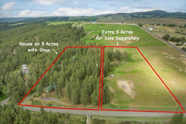 5217 E Stoughton Rd, Valleyford, WA 99036 - aerial view of sparsely populated area featuring property parcel outlined and a mountainous background