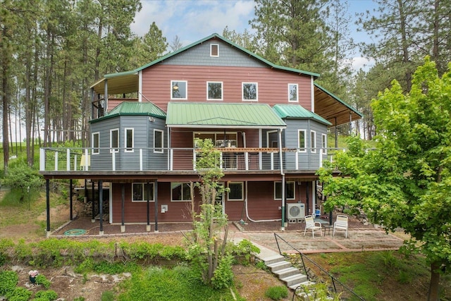 5217 E Stoughton Rd, Valleyford, WA 99036 - back of property with a patio, a wooden deck, ac unit, and metal roof