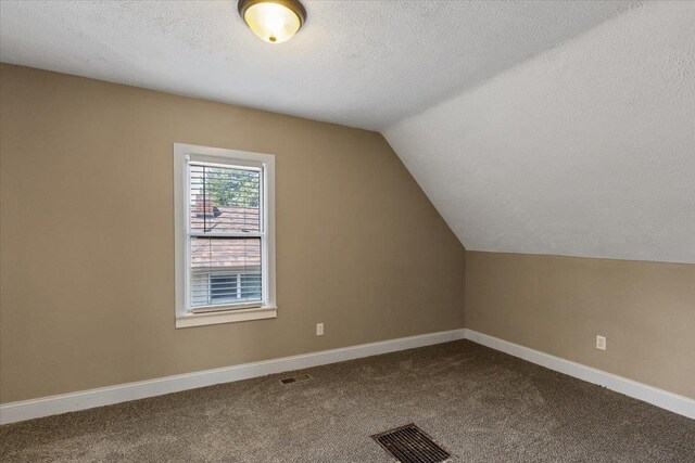 1721 E 12th Ave, Spokane, WA 99202 - bonus room with lofted ceiling, a textured ceiling, dark colored carpet, and baseboards