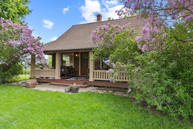8310 E Belair Rd, Valleyford, WA 99036 - rear view of house with a shingled roof, a yard, and a chimney