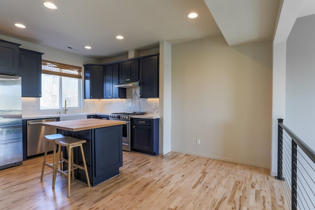 1810 W Summit Pkwy, Spokane, WA 99201 - kitchen featuring stainless steel appliances, butcher block countertops, light wood finished floors, under cabinet range hood, and a sink