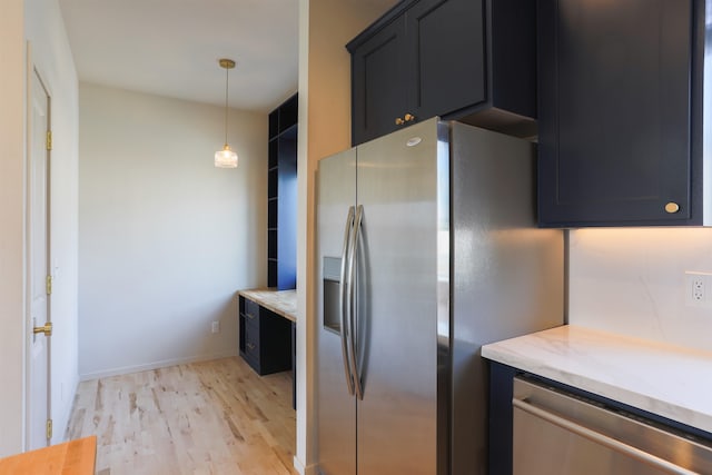 1810 W Summit Pkwy, Spokane, WA 99201 - kitchen with stainless steel appliances, light wood-style flooring, dark cabinetry, and light stone countertops