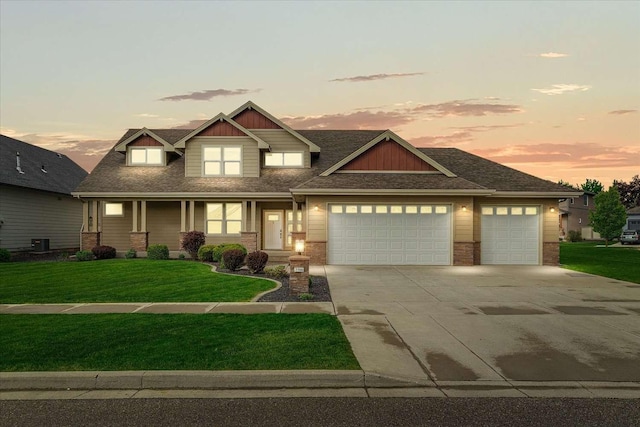 7708 N Warren Ln, Spokane, WA 99208 - craftsman-style house featuring an attached garage, concrete driveway, a front lawn, and brick siding