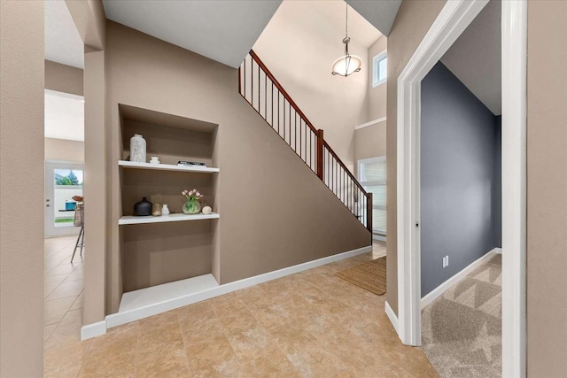 7708 N Warren Ln, Spokane, WA 99208 - stairway with healthy amount of natural light, baseboards, and built in shelves