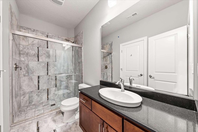 7708 N Warren Ln, Spokane, WA 99208 - full bath featuring a shower stall, vanity, and toilet