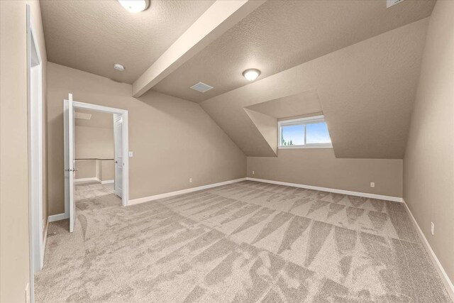 7708 N Warren Ln, Spokane, WA 99208 - bonus room featuring carpet, a textured ceiling, vaulted ceiling, and baseboards