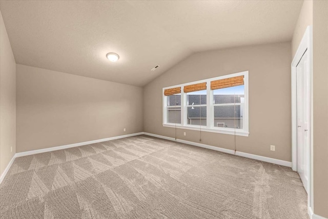 7708 N Warren Ln, Spokane, WA 99208 - unfurnished bedroom with carpet floors, lofted ceiling, and baseboards