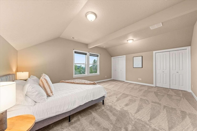 7708 N Warren Ln, Spokane, WA 99208 - bedroom with lofted ceiling, two closets, light carpet, and baseboards