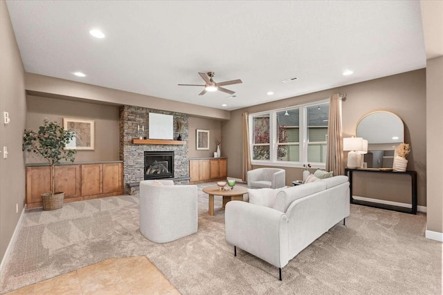 7708 N Warren Ln, Spokane, WA 99208 - carpeted living room with a ceiling fan, recessed lighting, a stone fireplace, and baseboards