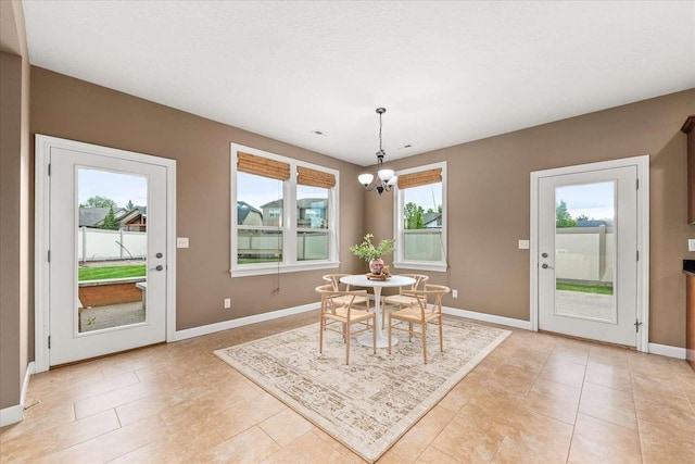 7708 N Warren Ln, Spokane, WA 99208 - dining room featuring plenty of natural light, a chandelier, and baseboards
