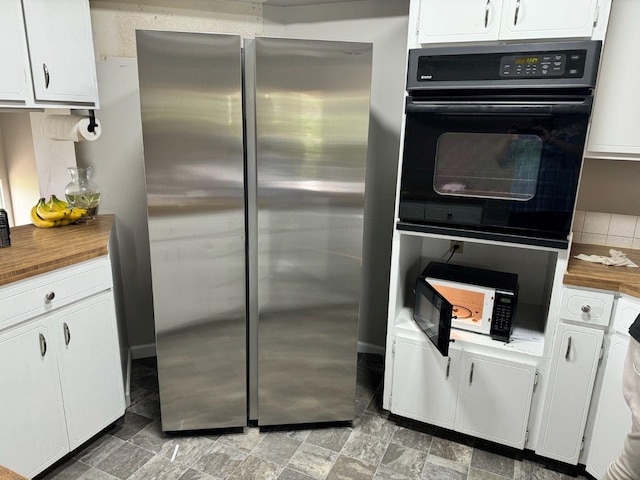 38821 N Newport Hwy, Elk, WA 99009 - kitchen with black appliances, wooden counters, and white cabinetry