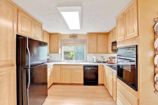 13227 N E Newman Lake Dr, Newman Lake, WA 99025 - kitchen with black appliances, light brown cabinetry, a textured ceiling, light wood-style flooring, and decorative backsplash